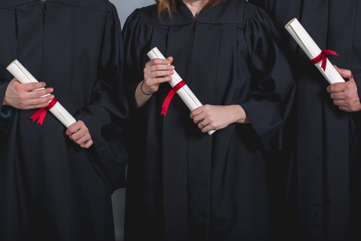 Stock three students holding diplomas 4 27