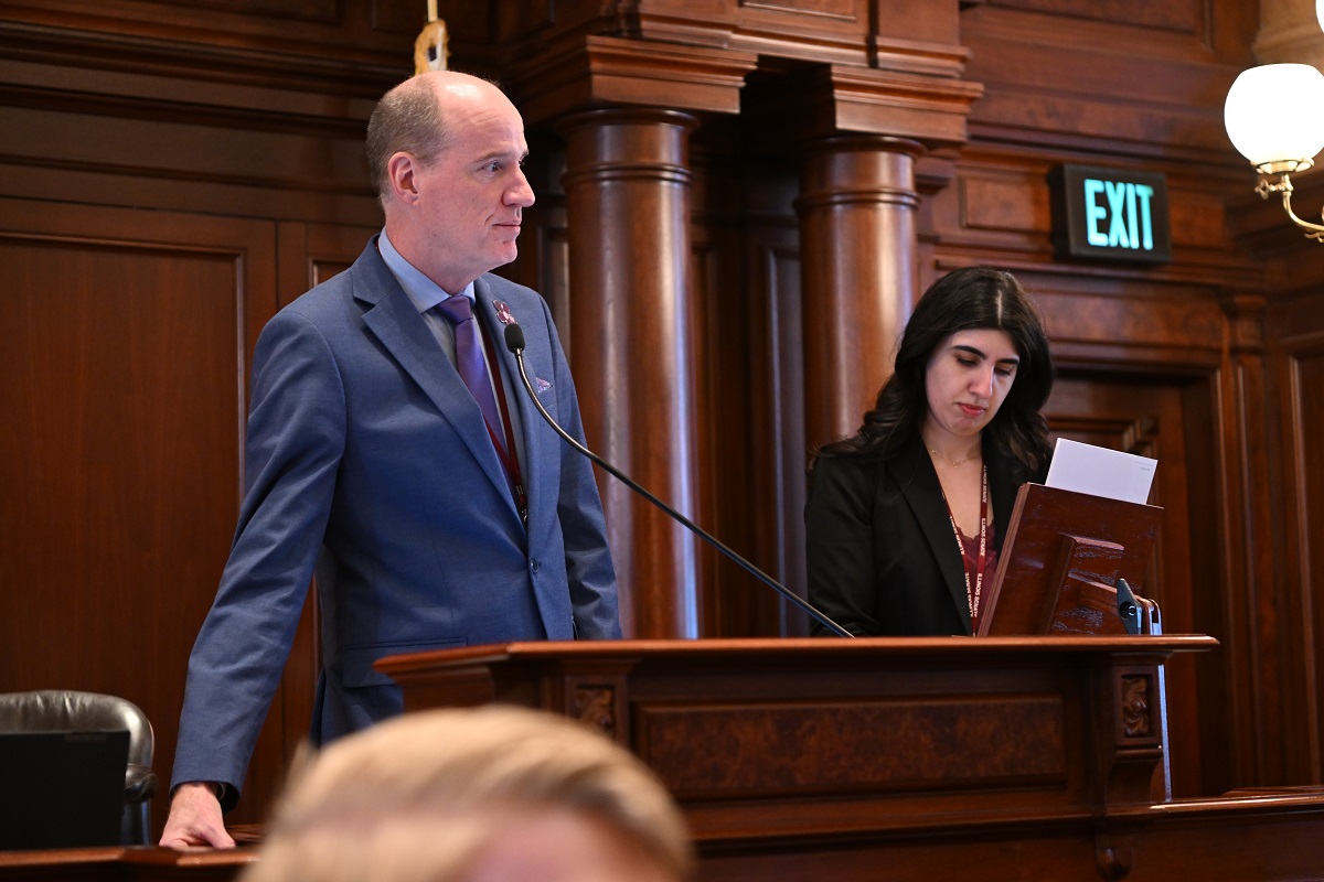 State Senator Bill Cunningham stands at the president's desk on the Senate floor