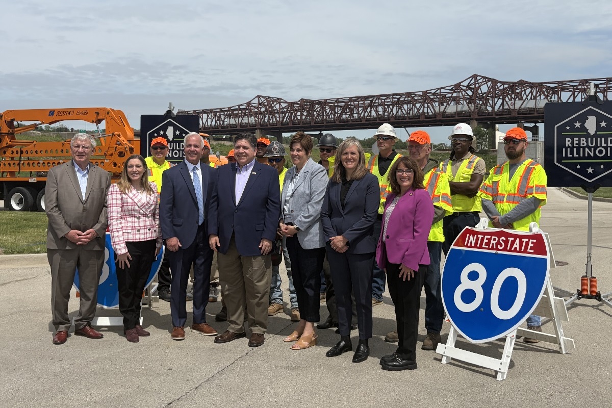State Senators Rachel Ventura and Meg Loughran Cappel stand with other public officials and construction workers at a press conference about the reconstruction of the I-80 bridge